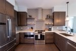 An exquisite kitchen with all modern, stainless-steel appliances and stocked with all the necessities